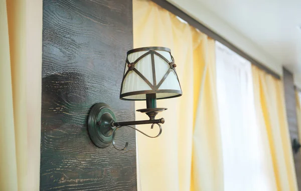 vintage wall lamp. The lamp on the wooden wall in the background window