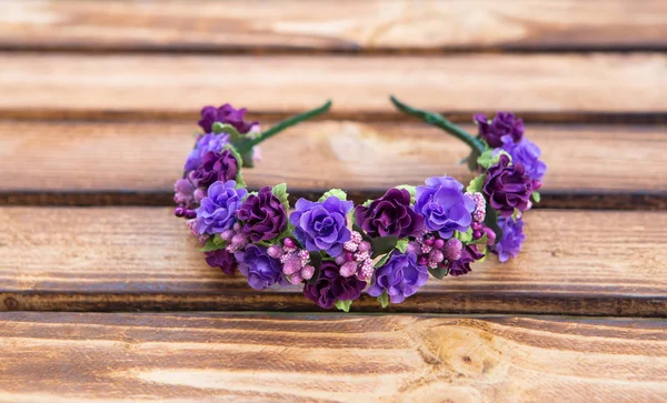 Handmade hoop purple flowers. Red and white hair band on wooden background — Stock Photo, Image