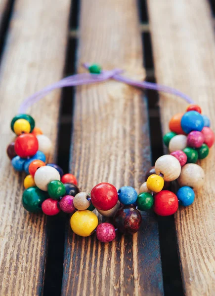 Multicolor beads handmade. Wooden background. Ukrainian style