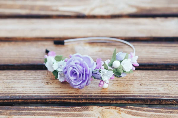 Handmade hoop purple flowers. Purple hair band on wooden background