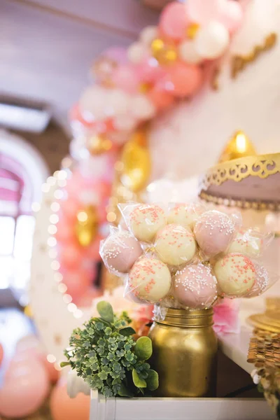 cakepops on holiday dessert table at kid birthday party.