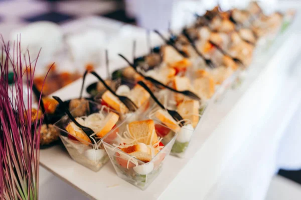 Luxury food and drinks on corporate party table.