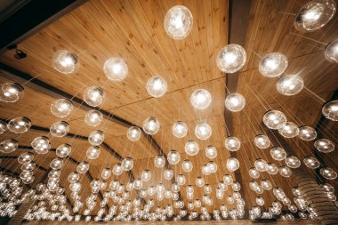 Ahşap arka planda tavandan sarkan lambalar