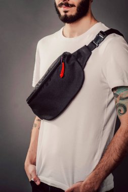 Beyaz tişörtlü, bel çantalı havalı sakallı hippi stüdyoda.