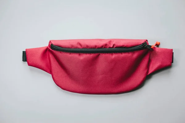 Waist bag of banana of red colour on a white background isolation