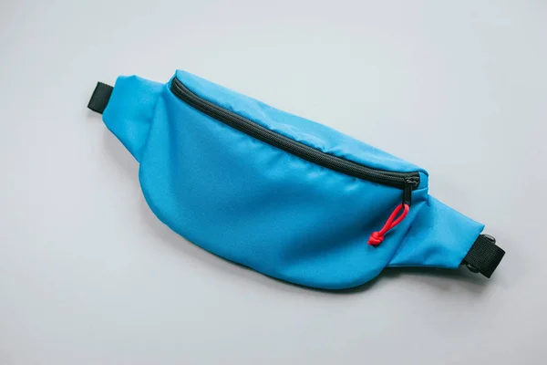 Waist bag of banana of blue colour on a white background isolation