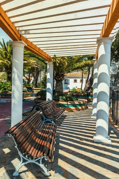 Sun shining over the arcade arch building, Mijas, Spain