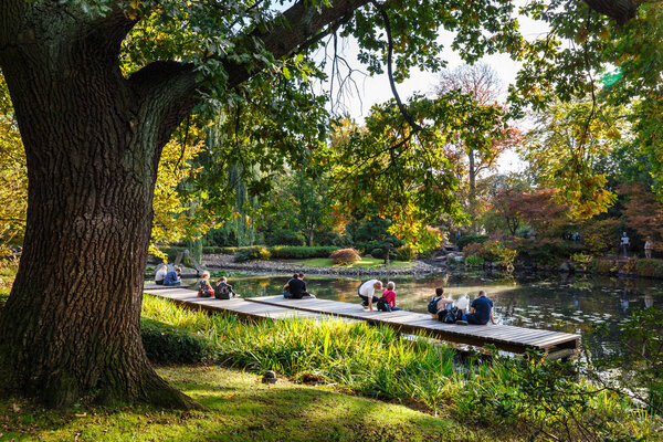 Wroclaw, Poland, October 06, 2018: group of unknown people relax in the Japanese garden in Wroclaw, Poland