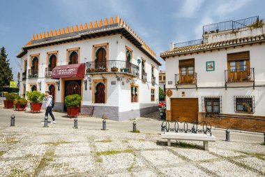 Granada, Spain, April 06, 2018: Street view of the historic district of Albaicin in Granada, Andalusia, Spain clipart