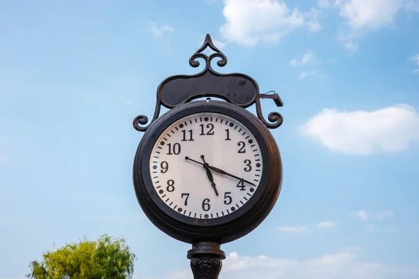 town clock on blue sky background, close up