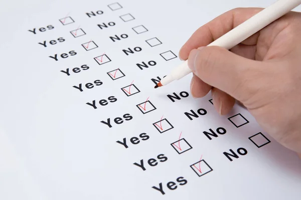 Man\'s hand checks all Yes checkboxes in order.
