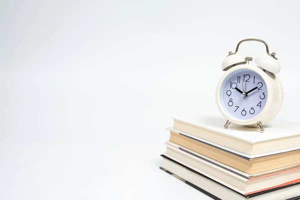 Alarm clock and books isolated on white background. — Stock Photo, Image