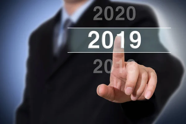 Businessman pointing year 2019. Businessman new year concept