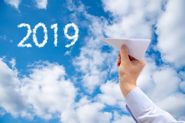 Kağıt Uçak gökyüzü arka plan üzerinde tutan işadamı el