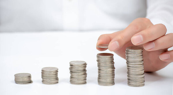 Hand of a business man pile up coins. Financial Concept.