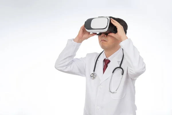 Male doctor wearing virtual reality glasses isolated on white background. — Stock Photo, Image