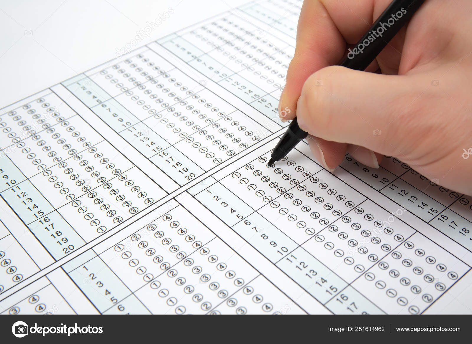 Man is filling OMR sheet handing with pen. Stock Photo by ©jypix 251614962