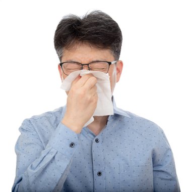A middle-aged man suffering from rhinitis on white background. clipart