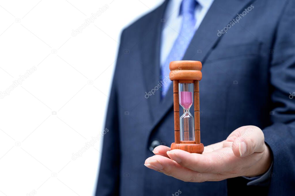 Businessman hand holding hourglass, Time management concept.