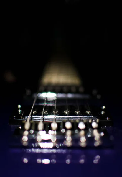 Electric guitar closeup on black background.