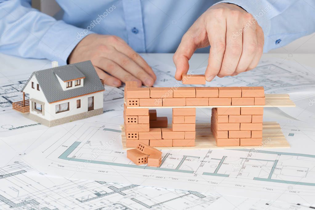 construction with brick on blueprint. Architect building model house