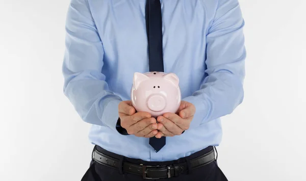 Close up of  businessman holding pig money box in hands. — Stock Photo, Image