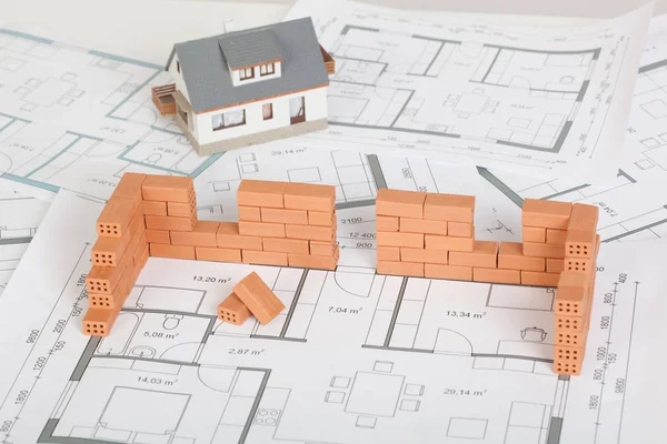Model house construction with brick on blueprint — Stock Photo, Image