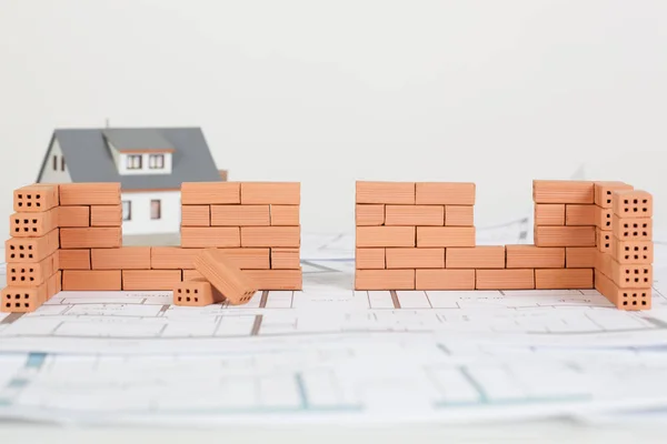 Model house construction with brick on blueprint — Stock Photo, Image