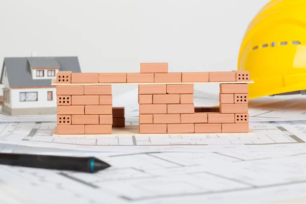 Model house construction with brick on blueprint — Stock Photo, Image