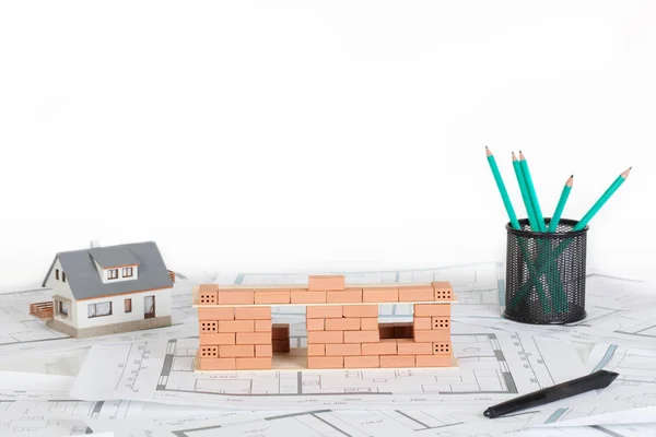 Model house construction with brick on blueprint. — Stock Photo, Image