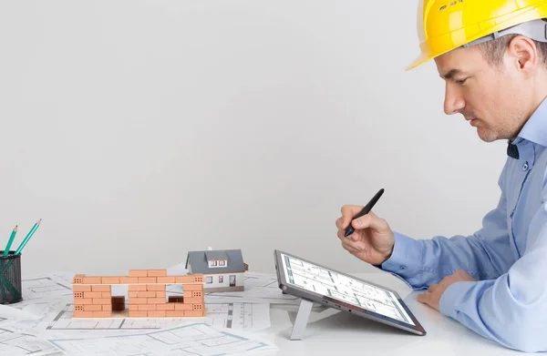 Architect met behulp van digitale tablet op kantoor tafel. — Stockfoto