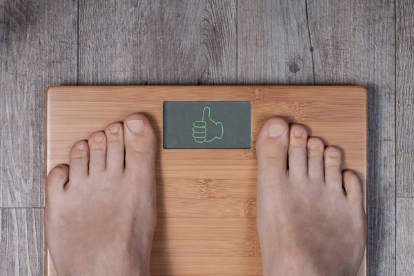 Good weight. Thumb up gesture on weight scale — Stock Photo, Image