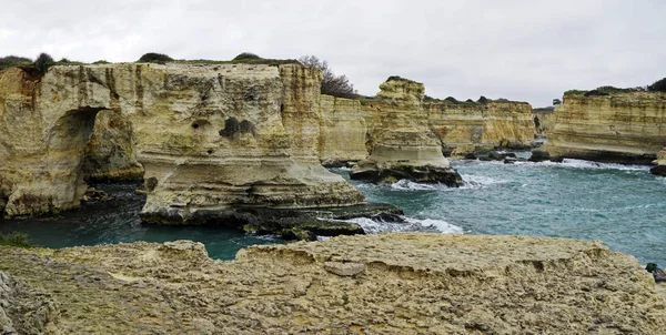 Malebná krajina s útesy, skalní oblouk a hromádky faraglioni, v Torre Sant Andrea, Salento moře pobřeží, Puglia, Itálie — Stock fotografie