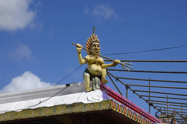 Malá socha lorda Šivy na střeše jednoho z mnoha hinduistických chrámů na Mauriciu — Stock fotografie