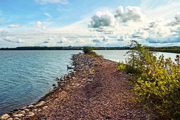View from a breakwall on Onondaga Lake in Geddes, New York with the city of Syracuse in the distance
