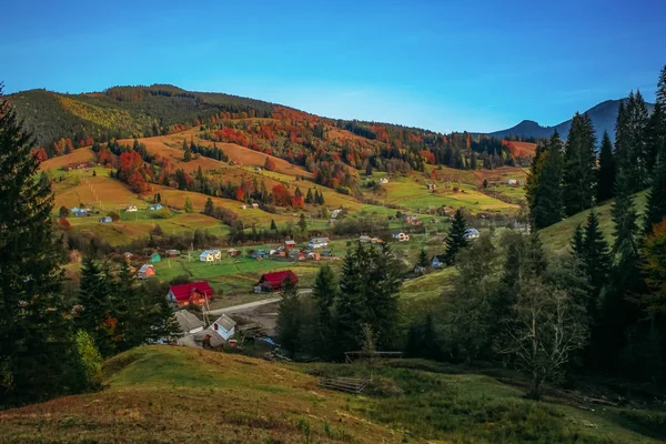 Autumn in the mountains. Mountains, forests and fields in autumn colors