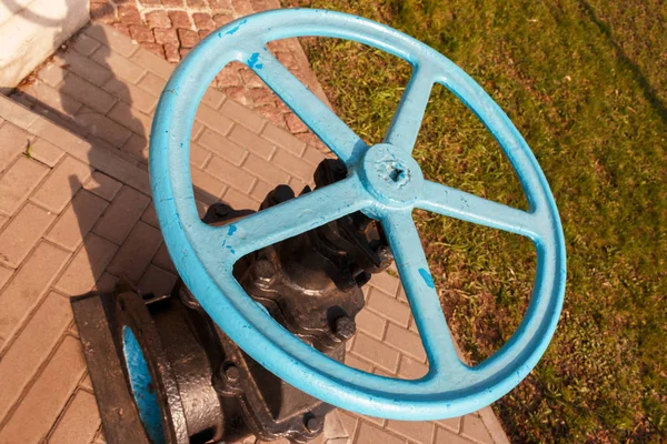 close-up of blue valve for controlling the output of liquids, steam or gas in certain mechanisms