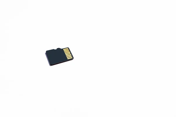 Black micro SD memory card isolated on white background. Memory card for digital file. Flash drive lie on a white surface