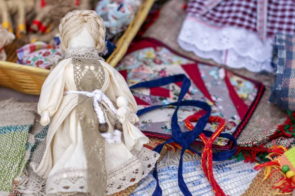 handmade folk doll made of cloth without a face in a beautiful dress