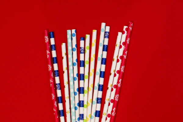 Cocktail tubes for drinks on a red background — Stock Photo, Image