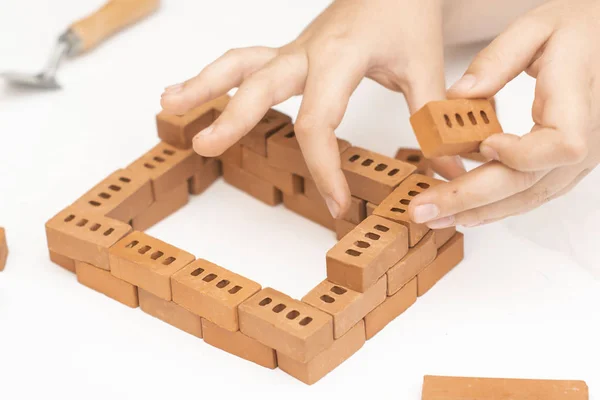 Construction of small brick blocks, toy for child development on white background. — Stock Photo, Image