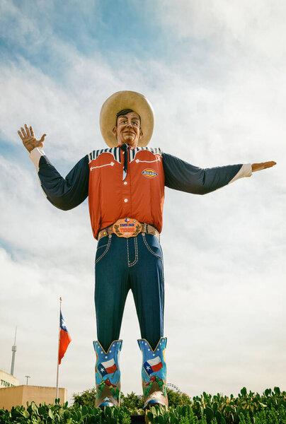 Dallas, Texas - October 17, 2019: Big Tex statue standing tall at Fair Park. The icon greets and waves his hands to welcome visitors at the Texas State Fair fairgrounds. 