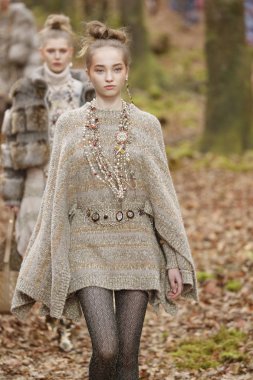 PARIS, FRANCE - MARCH 06: A model walks the runway during the Chanel show as part of the Paris Fashion Week Womenswear Fall/Winter 2018/2019 on March 6, 2018 in Paris, France.  clipart