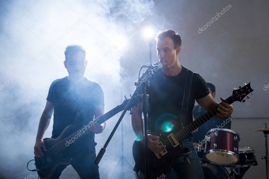 Two guys playing electric guitar and singing on stage