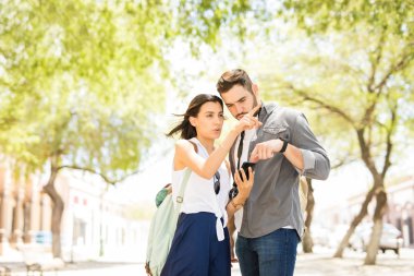 Tatil seyahat ederken konumu bulmak için smartphone kullanarak turist backpackers genç çift