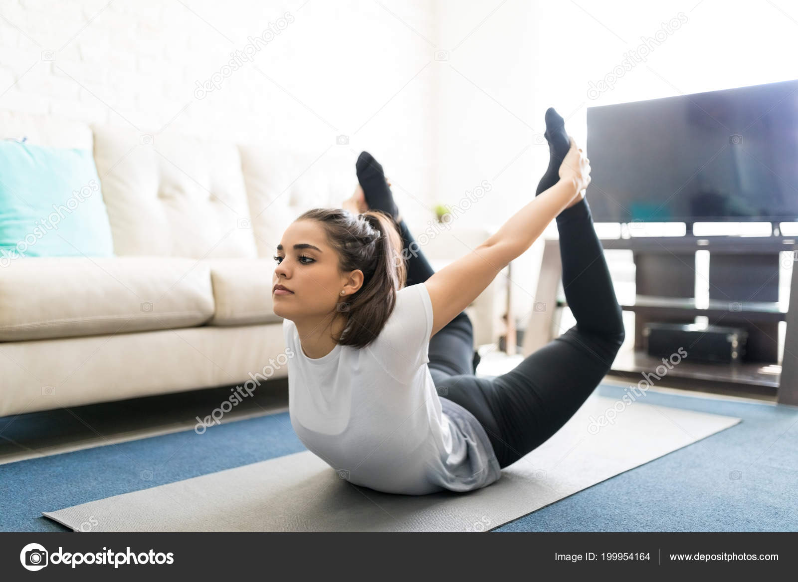 Fit Young Woman Bending Backwards Holding Legs Bow Pose Yoga