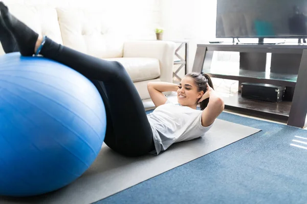 Fit Latina Žena Dělá Sit Ups Míčem Cvičení Doma Obývacím — Stock fotografie