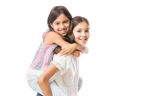Latin elder sister carrying younger sister on her back isolated over white background — Stock Image Latin Elder Sister Carrying Younger Sister Her Back Isolated White Stock Image