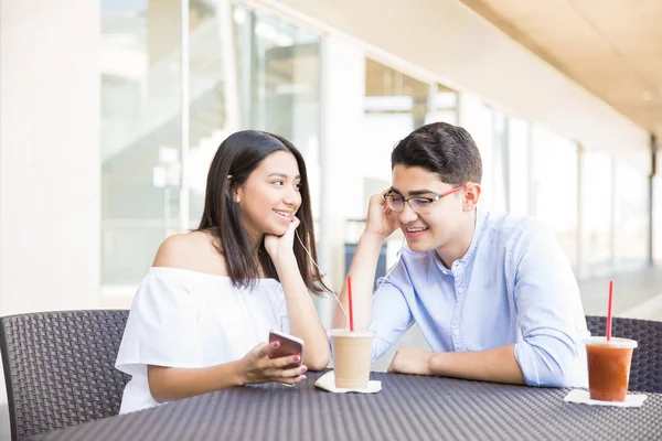 Gülümseyen genç kız ile alışveriş merkezi aşık erkek bakarken müzik