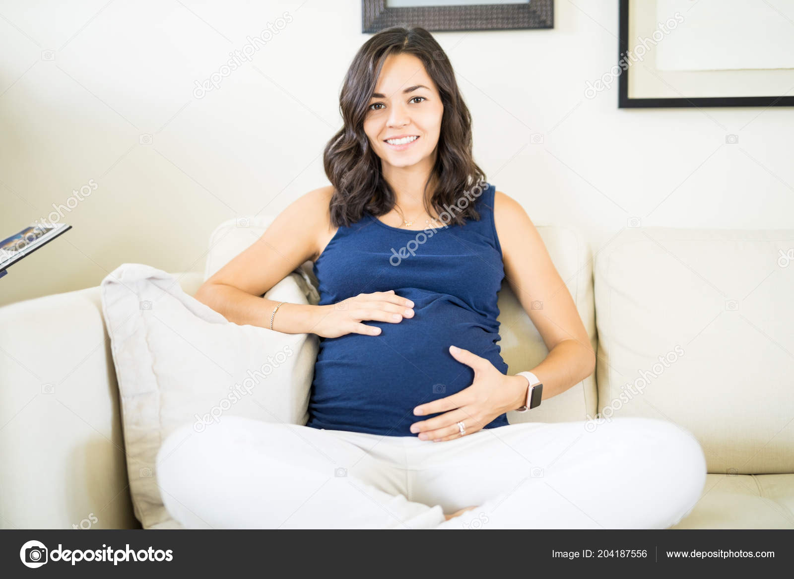 Beautiful Young Pregnant Woman Touching Her Belly Smiling While
